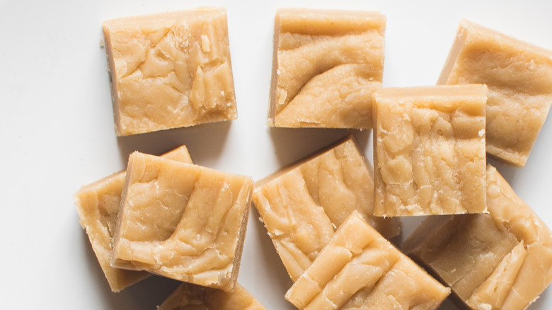 Cubes of peanut butter fudge on a white plate