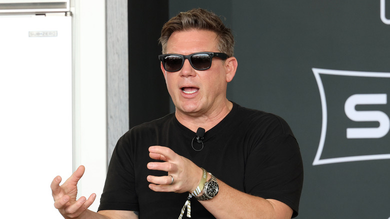 Tyler Florence conducting a recipe demonstration wearing sunglasses on stage