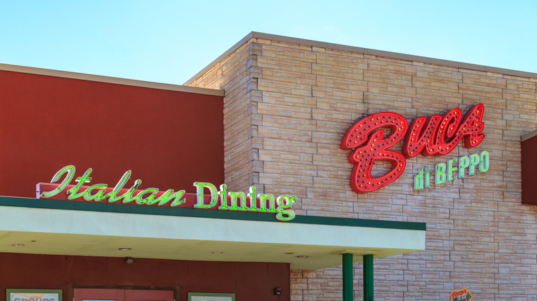 Buca di Beppo restaurant exterior on bright day with stylish restaurant neon signs