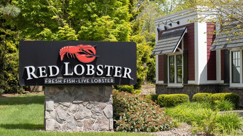 Red Lobster restaurant exterior with red lobster sign in manicured garden outside restaurant