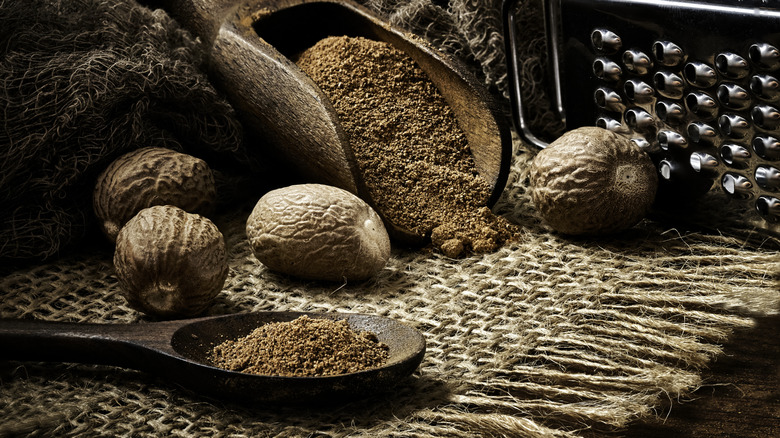 nutmeg nuts and grated nutmeg laid out on a table