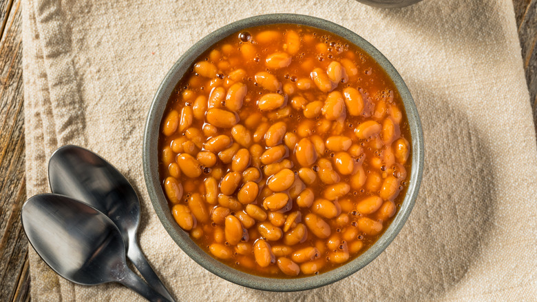 Baked beans with wooden spoon