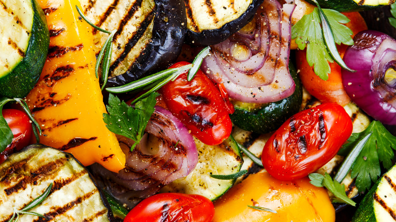 Close up of grilled peppers, tomatoes, onions, eggplant, and zucchini