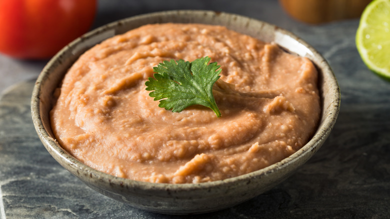 Bowl of refried beans with cilantro garnish