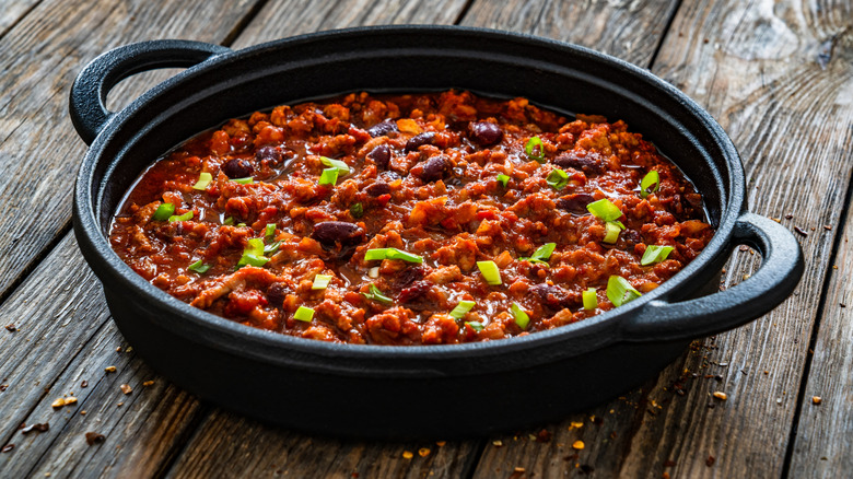 a cast iron dish with chili