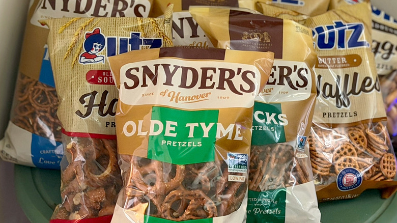 several bags of Utz and Snyder's of Hanover pretzels on a table