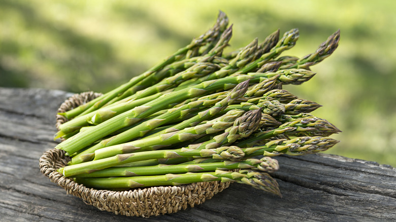 asparagus in a basket on an outdoor table