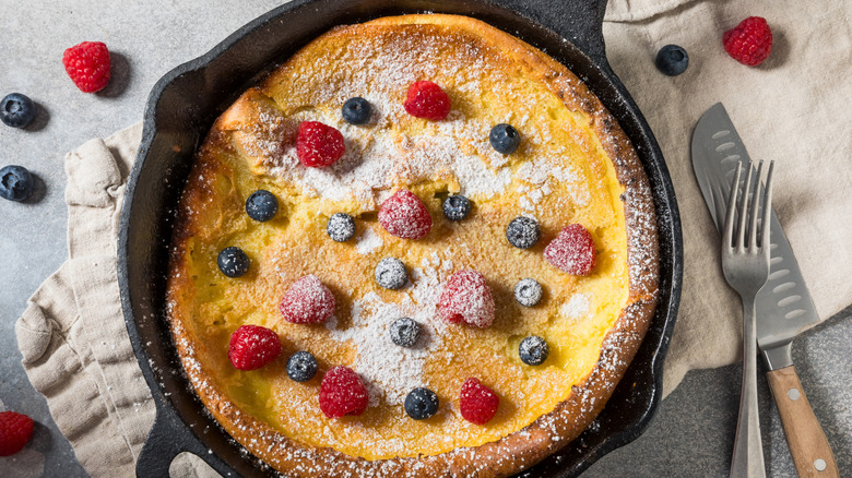 Dutchy baby pancake in a cast iron pan with fresh berries