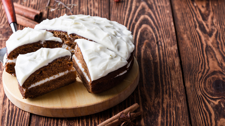 Spice Cake Sliced with Cream Cheese Frosting on Rustic Table