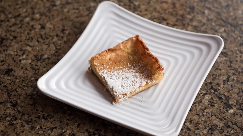 A slice of butter cake on a white plate