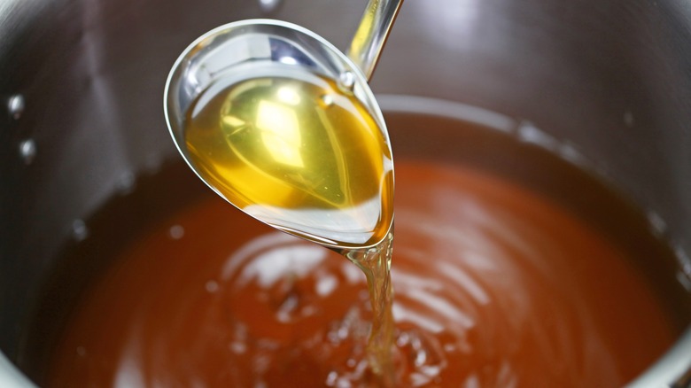 Consomme in a pot with a ladle
