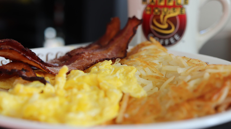 Closeup of plate of Waffle House scrambled eggs, hash browns, and bacon