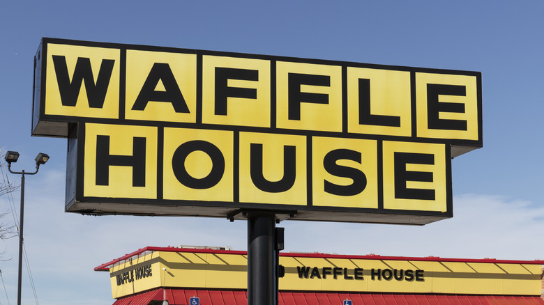 A large Waffle House sign in front of a Waffle House location.