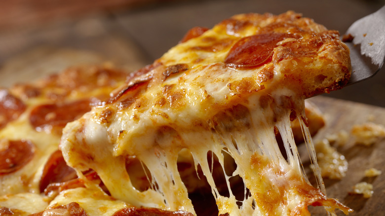 Pepperoni pizza slice with cheese-pull