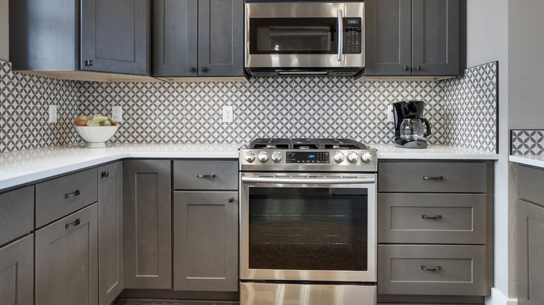 A kitchen with an oven and microwave prominently displayed