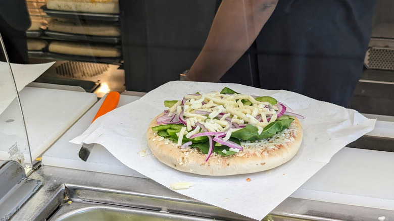 Subway pizza being made