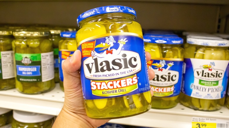 A jar of Vlasic pickles being held up for the camera.