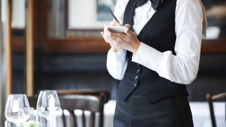 A restaurant server taking an order