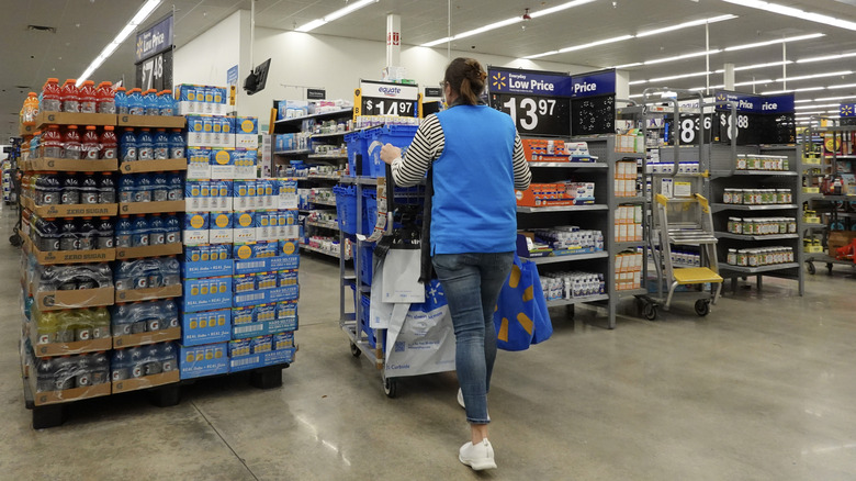 Walmart employee stocking shelves
