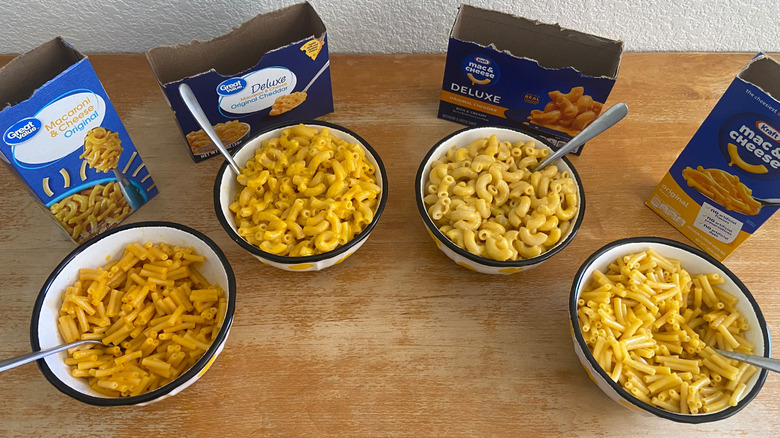 top-down view of all four kinds of mac & cheese beside their respective boxes