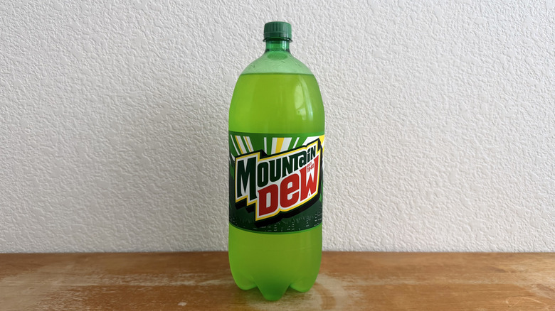 two-liter bottle of Mountain Dew on wooden table