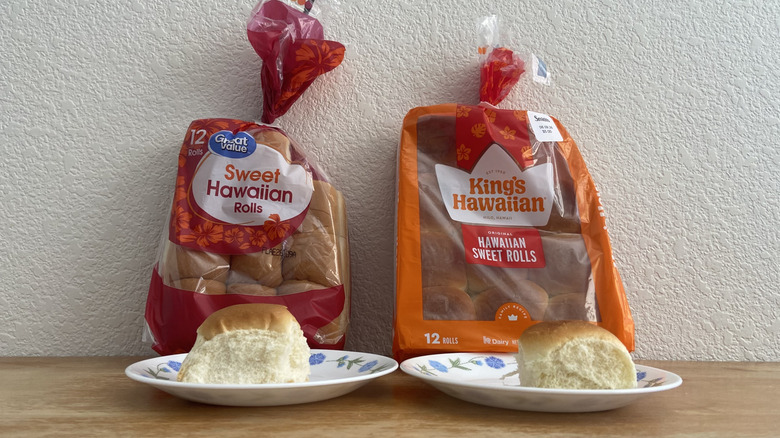 Both kinds of rolls on small plates with their respective bags in the background