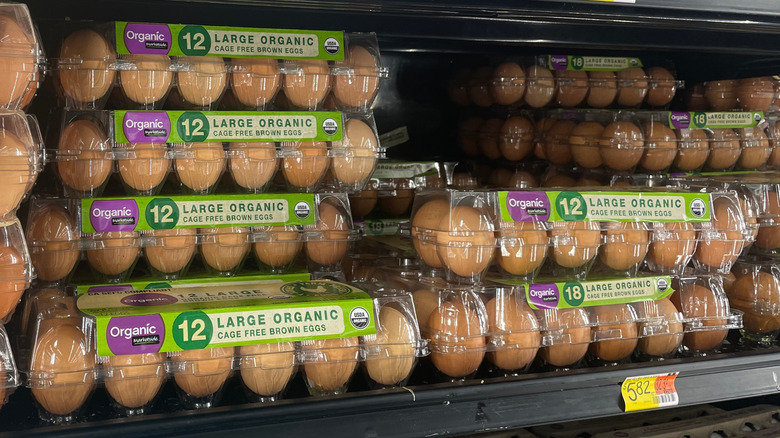 Marketside Organic cage free brown eggs stacked on refrigerator grocery shelf