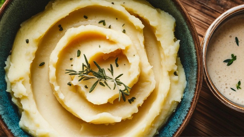 Fluffy mashed potatoes with herbs close up
