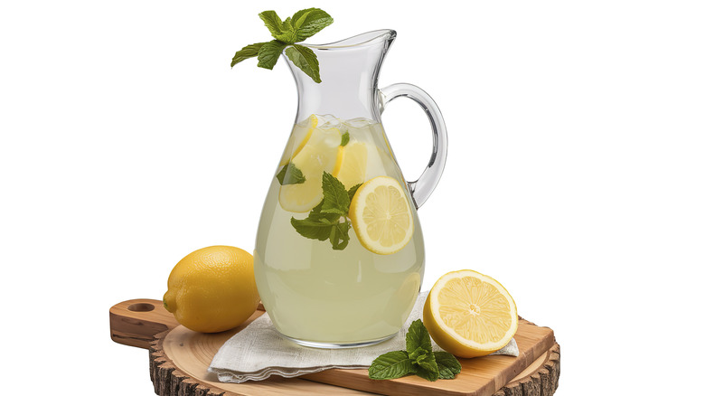 A pitcher of homemade lemonade and mint leaves