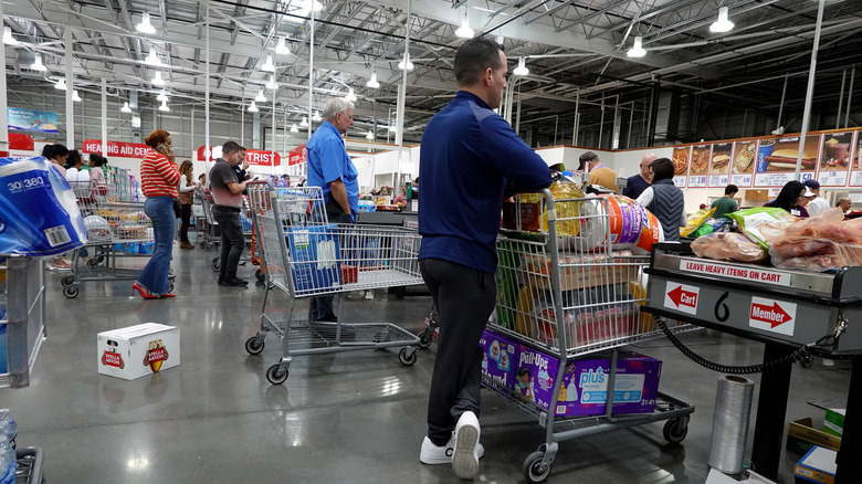 Customers waiting at a Costco checkout