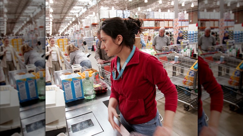 Cashier ringing up items at Costco