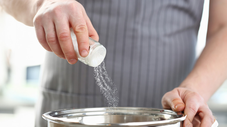 Chef Wearing Apron Adding Dish White Sea Salt