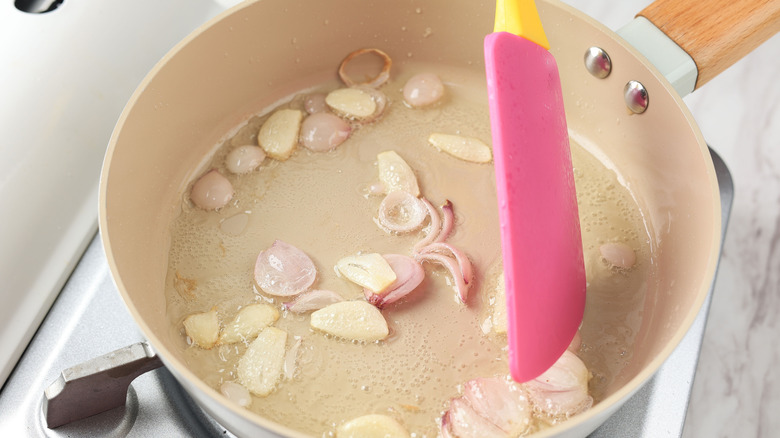 Close Up Sauteeing Garlic and Shallots in a Nonstick Frying Pan