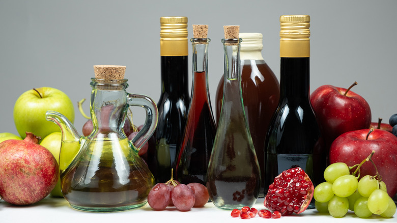 Different types of vinegar, apple, balsamic, wine and pomegranate vinegars in bottles.
