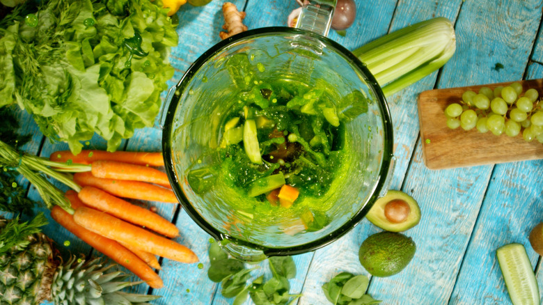 Pieces of fruit and vegetables in a blender