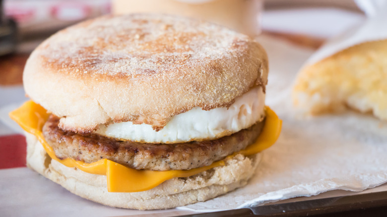 Fast food English muffin breakfast sandwich with sausage, eggs, and cheese