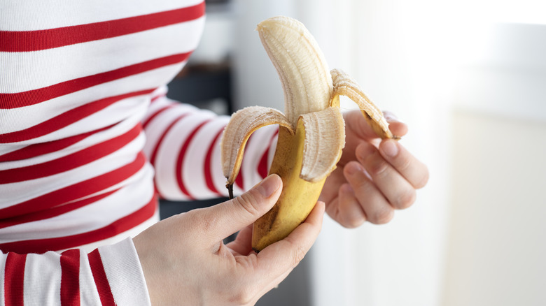 Person peeling a banana
