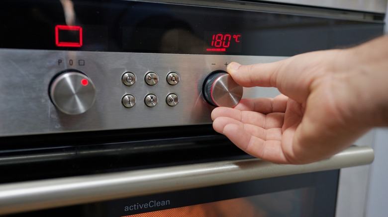 Person turning oven on