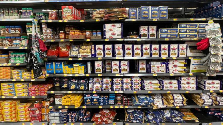 Walmart pasta aisle with assorted products on shelves.