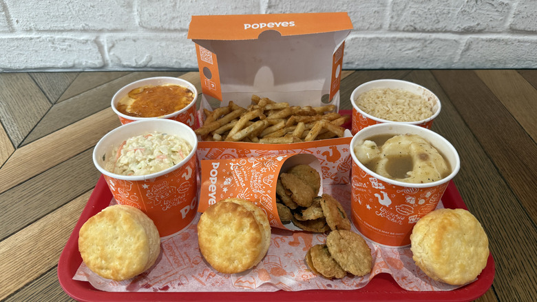 A tray filled with Popeyes side items