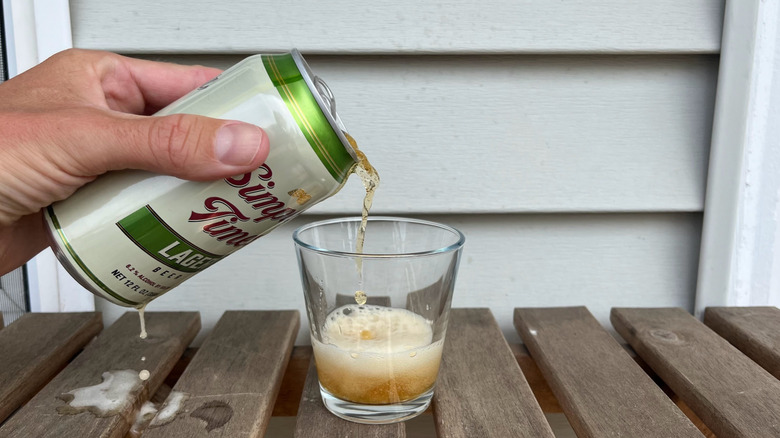 Simpler Times Lager pouring into a glass