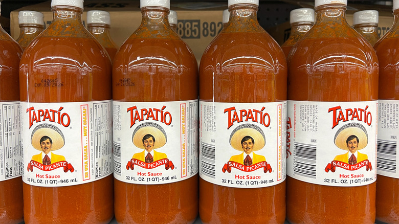 A grocery shelf of Tapatio hot sauce bottles
