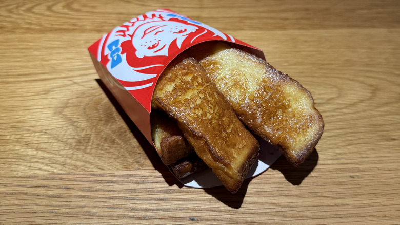 A cup of Homestyle French Toast Sticks on a table