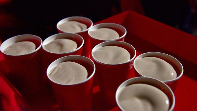 Multiple red cups filled with chocolate frostys