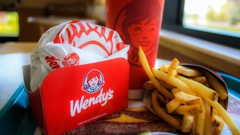 A Wendy's sandwich with fries and a drink