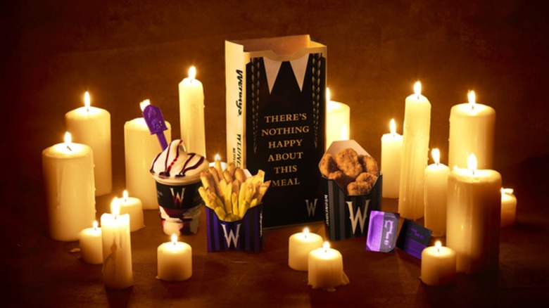 Wendy's new collaborative happy meal surrounded by lit candles