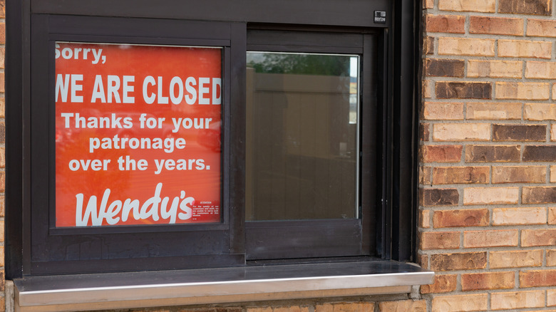 "closed" sign in a Wendy's drive-thru window