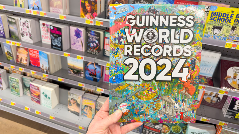 Hand holding the 2024 Guinness World Records book