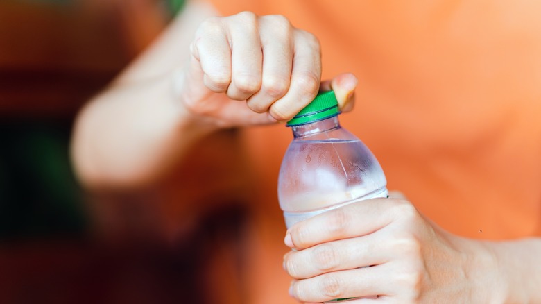Woman holds water bottle