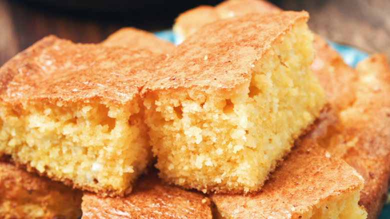 a plate with pieces of freshly baked cornbread stacked on top